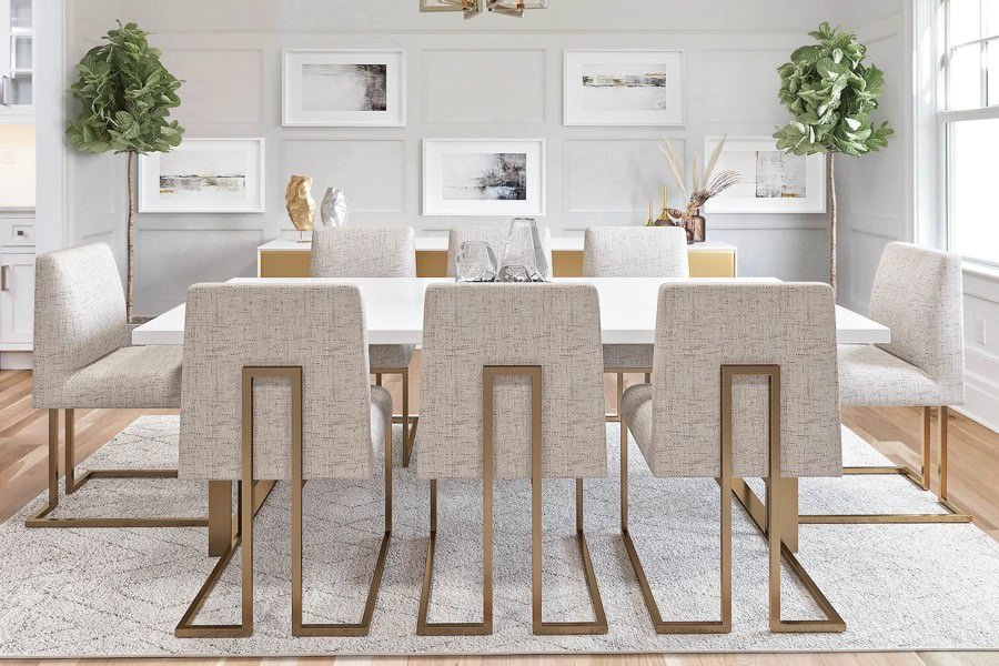 Bright and airy dining room with neutral furnishings, gold-framed abstract artwork, and soft natural lighting in california