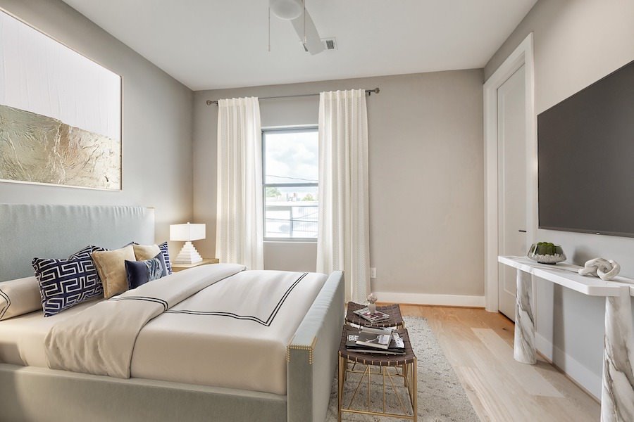 Virtually staged bedroom with light tones and marble console