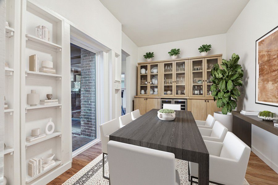 Contemporary dining area with a sleek black table, white chairs, and built-in display shelving with decorative items.
