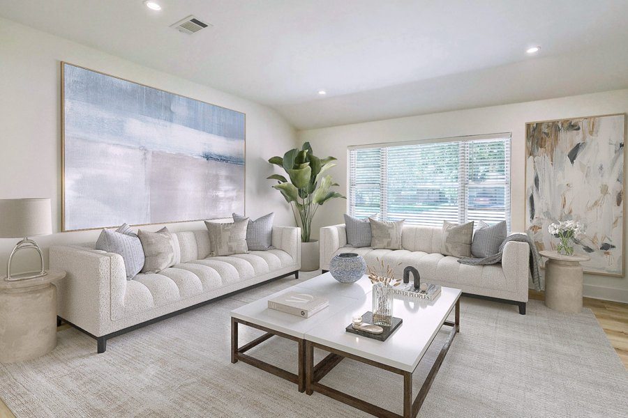 Virtually staged living room with a white sofa, marble coffee table, abstract art, and neutral tones