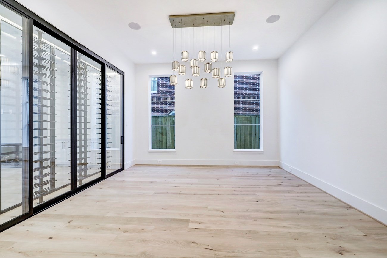 Minimalist dining space with pendant lights and light floors
