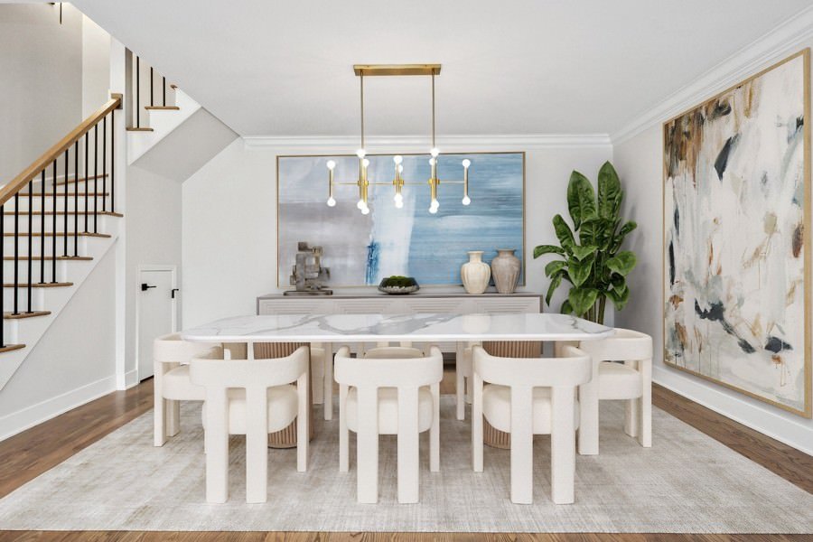 Elegantly staged dining room featuring a marble-top table, sculptural lighting, and abstract modern artwork.