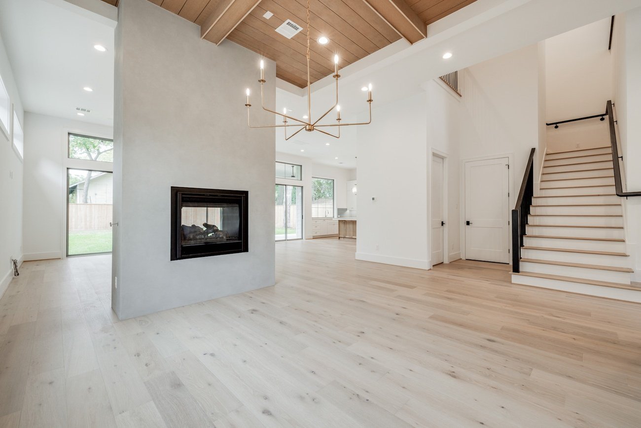 Open dining space with fireplace and staircase