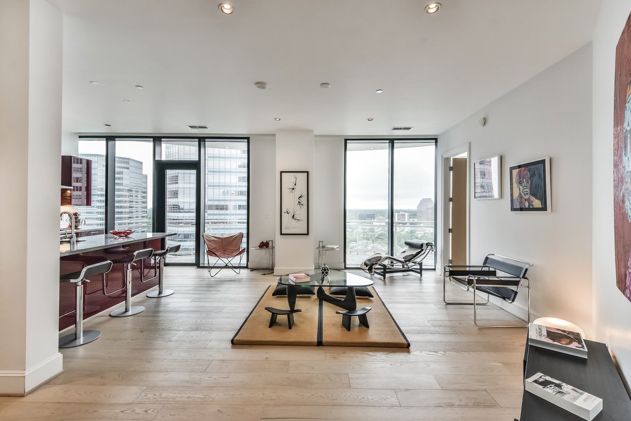 Alt text: Bare open-concept living room space with hardwood floors, ideal for virtual home staging
