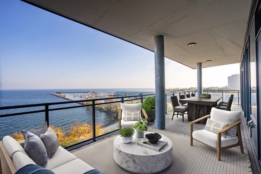 Virtually staged luxury balcony with lake views and modern furniture