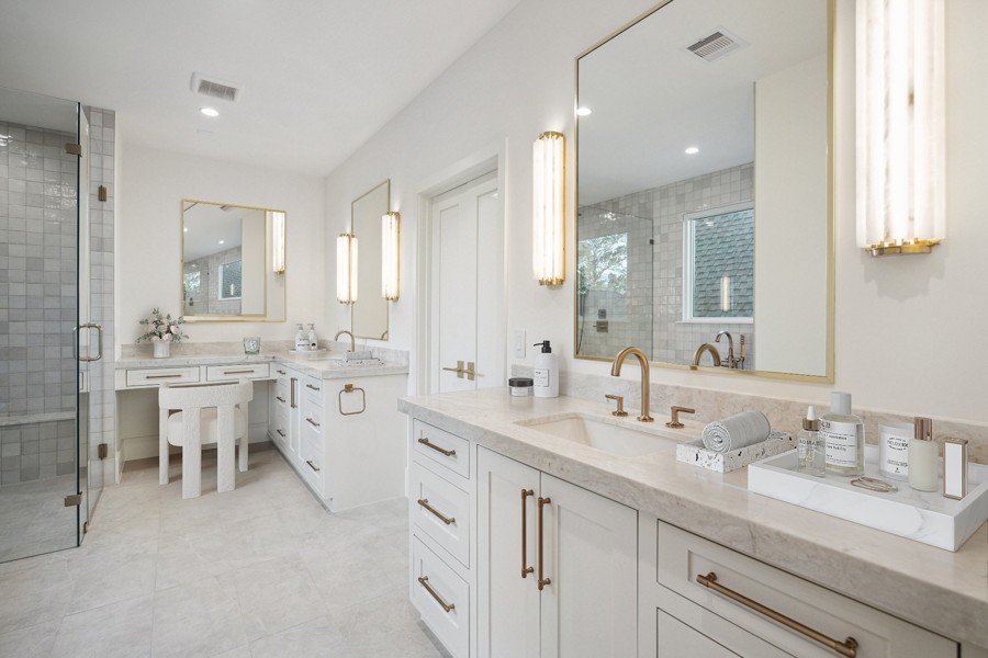 Luxury bathroom virtually staged with a double vanity and gold fixtures