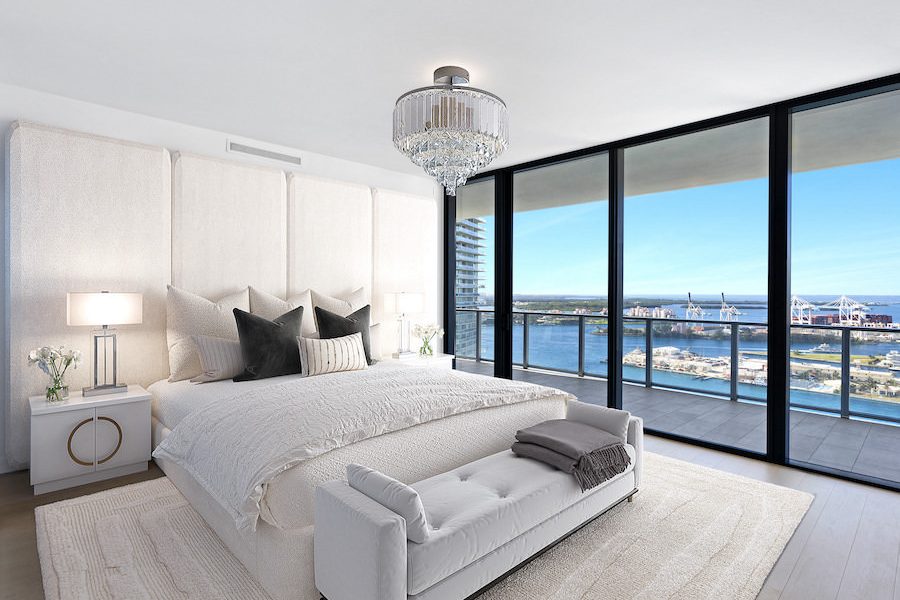 Modern bedroom digitally staged with sleek white furnishings and city view.