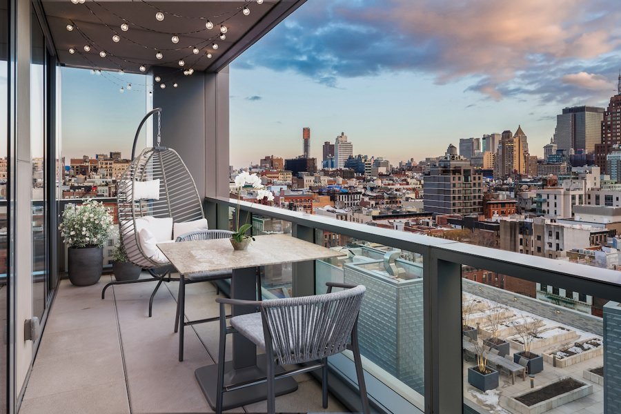Urban balcony virtually staged with contemporary dining set and skyline views