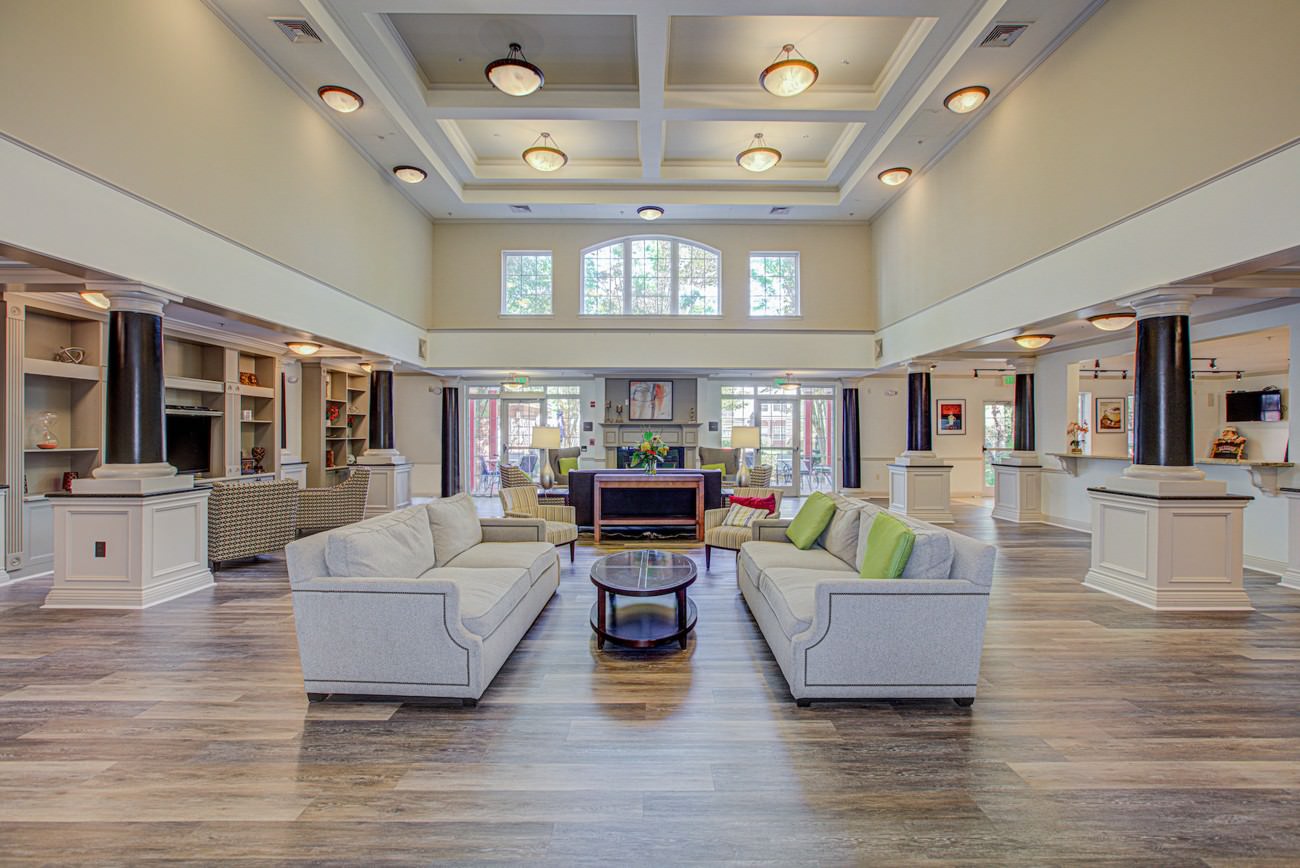 Clubhouse lounge area with traditional furnishings and basic layout before virtual redesign.