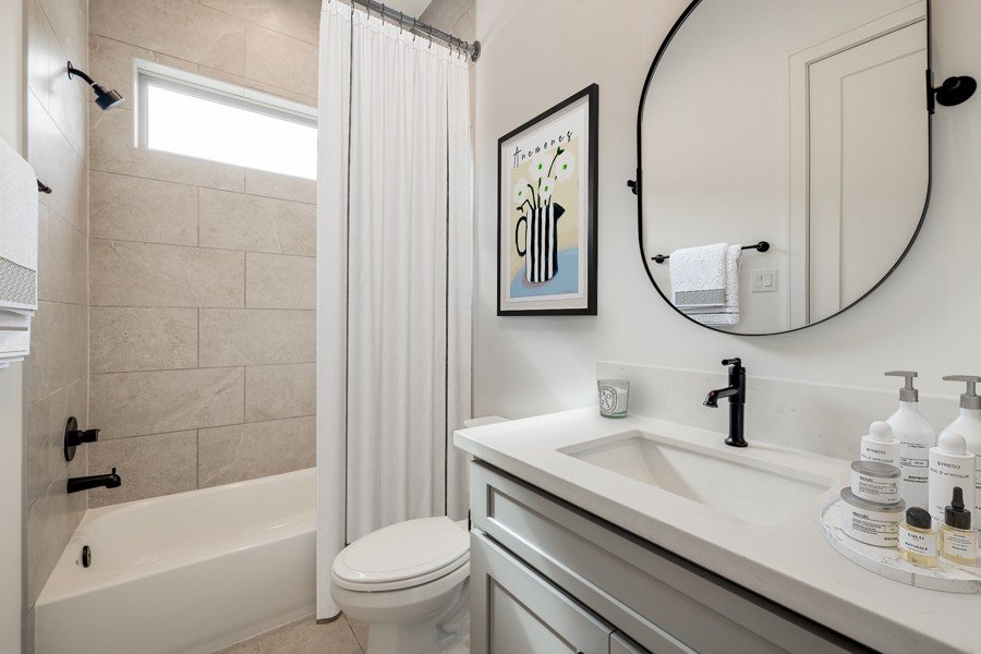 Neutral bathroom virtually staged with soft finishes and updated fixtures