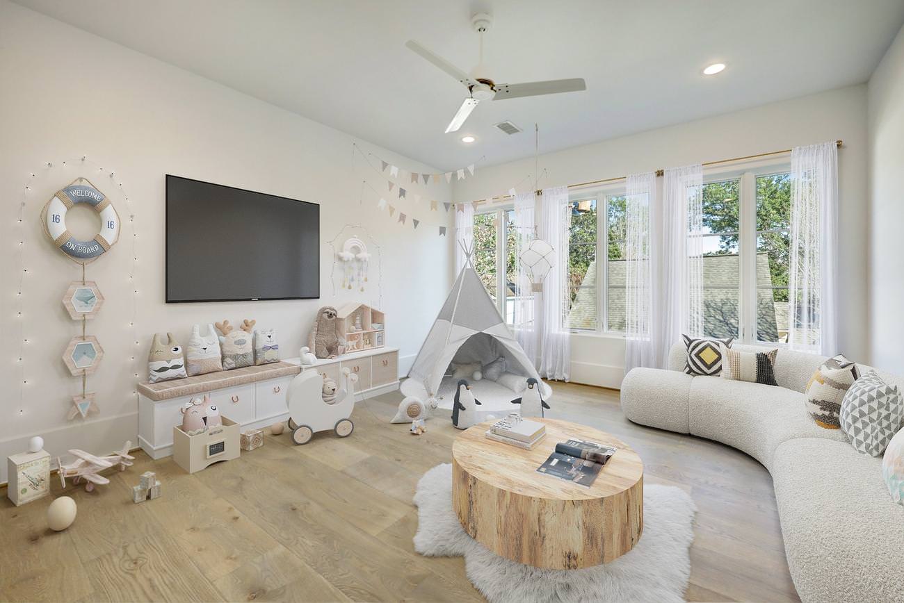 Spacious children's playroom with curved cream sofa, wood coffee table, and white teepee tent