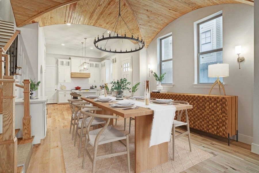 Rustic dining room with a wood-beamed vaulted ceiling, natural textures, and a long farmhouse-style table.