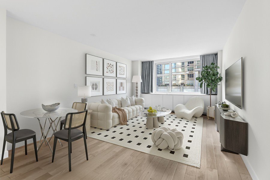 New York City sunlit apartment living and dining space featuring a curved accent chair, grid-style wall gallery, and a blend of classic and modern furnishings.