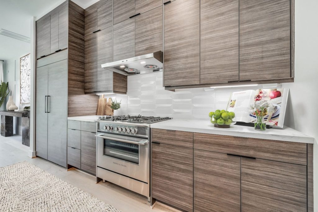 Virtually staged modern kitchen with decor accents, fresh produce, and added design warmth.
