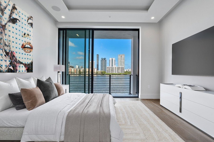 Virtual staging of a Miami bedroom with ocean view and large format artwork
