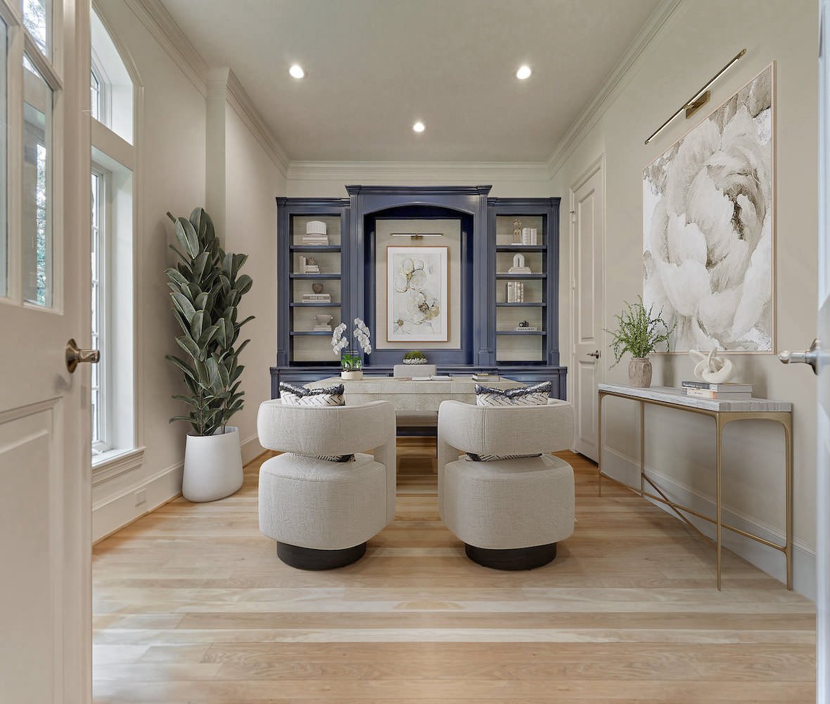 Virtually staged home office with blue built-in shelving and modern furniture.