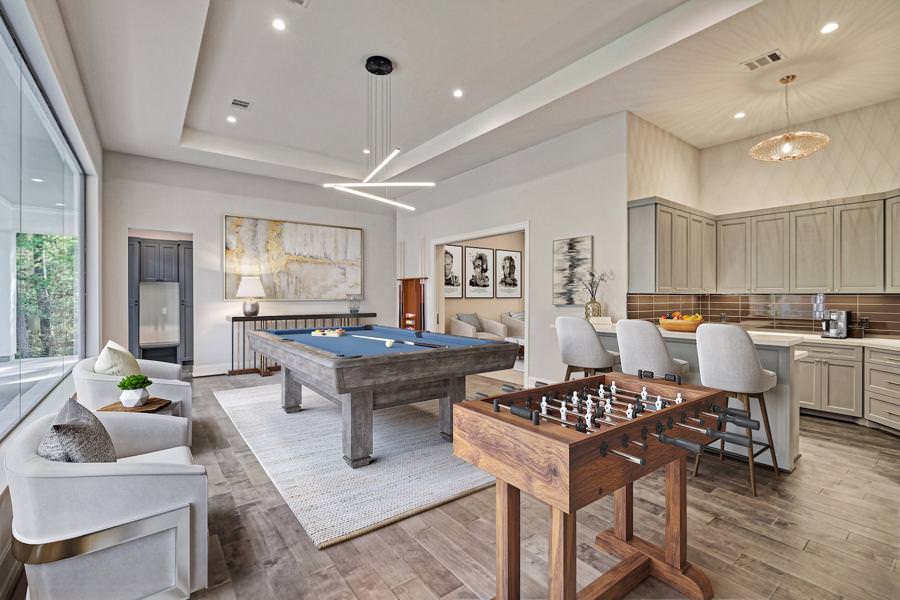 Contemporary open-concept game room with pool table and Foosball near a kitchen bar in texas