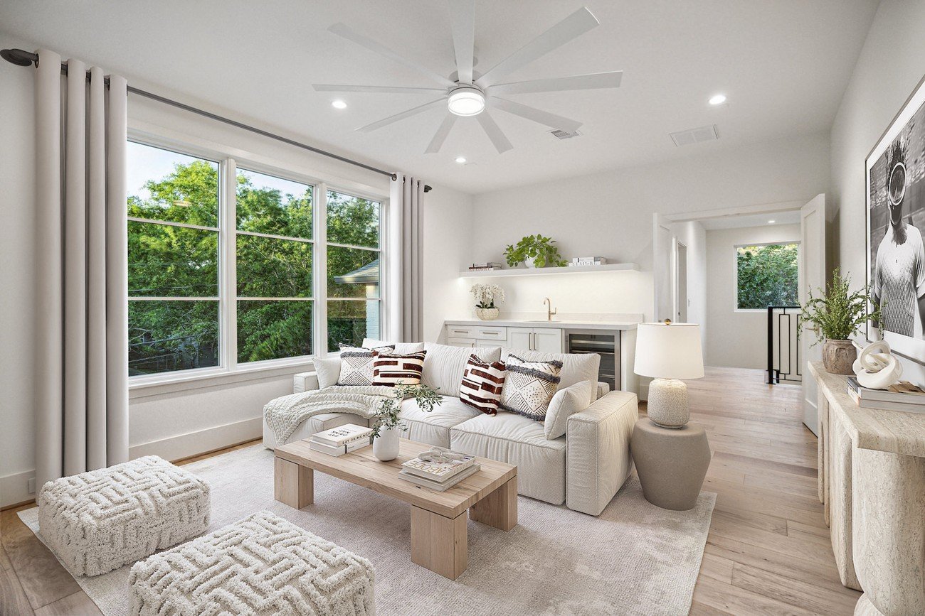 Virtually staged lounge showcasing neutral-toned furniture, decorative accents, and soft natural lighting.