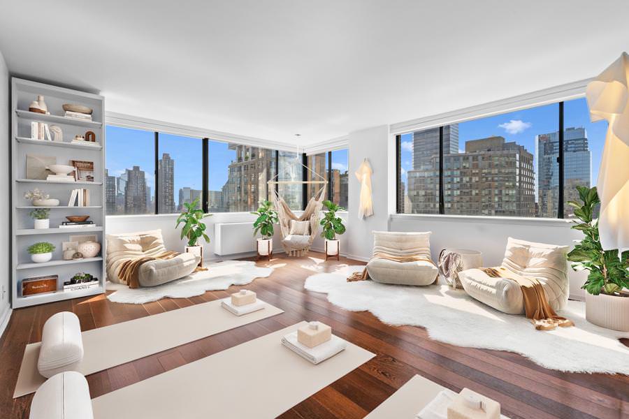 Virtual staging of a bright yoga and meditation room with large windows, lounge chairs, and city skyline views.
